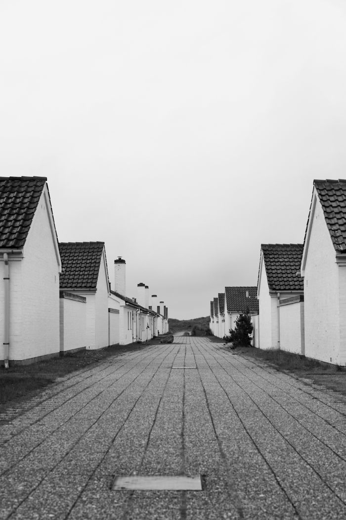 Crafting Captivating Headlines: Your awesome post title goes here Peaceful black and white view of a Danish residential street lined with white houses.